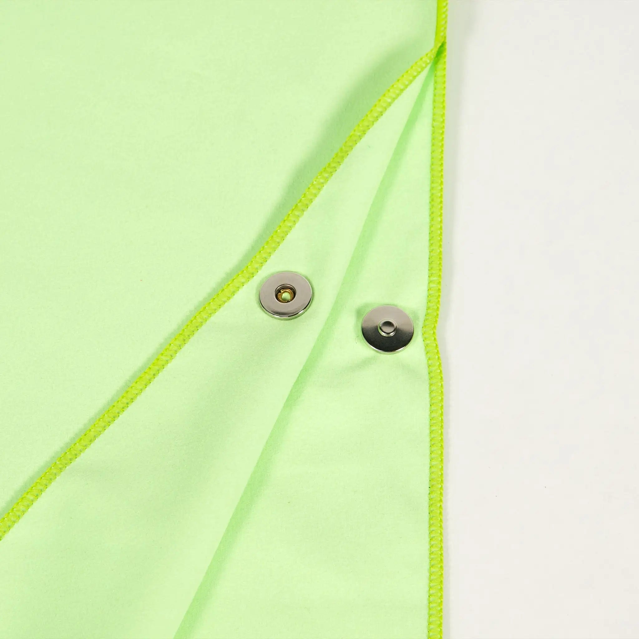 Close-up of StayDry absorbent green hooded towel fabric with durable snap button closure, designed for quick-drying after swimming, beach or shower use.