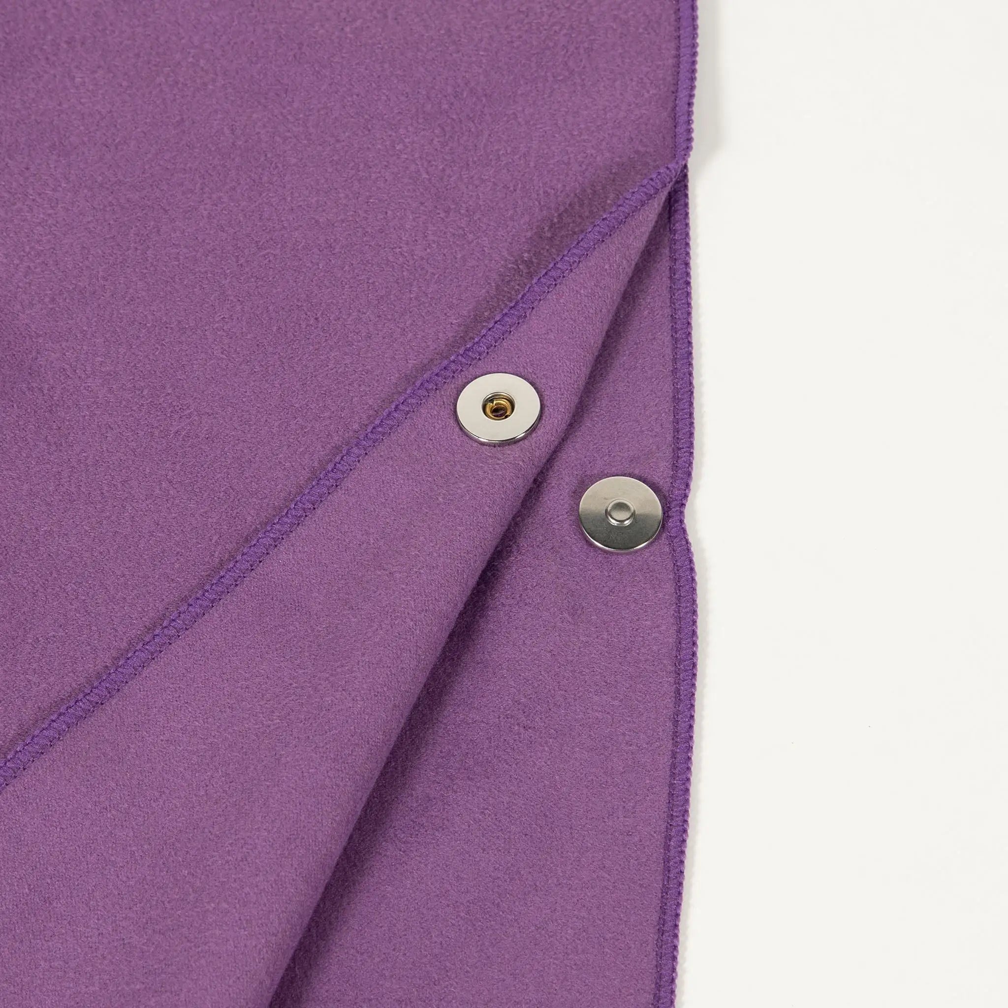 Close-up of StayDry microfibre hooded poncho towel in purple, highlighting snap button closure and ultra-absorbent fabric for quick-drying comfort.