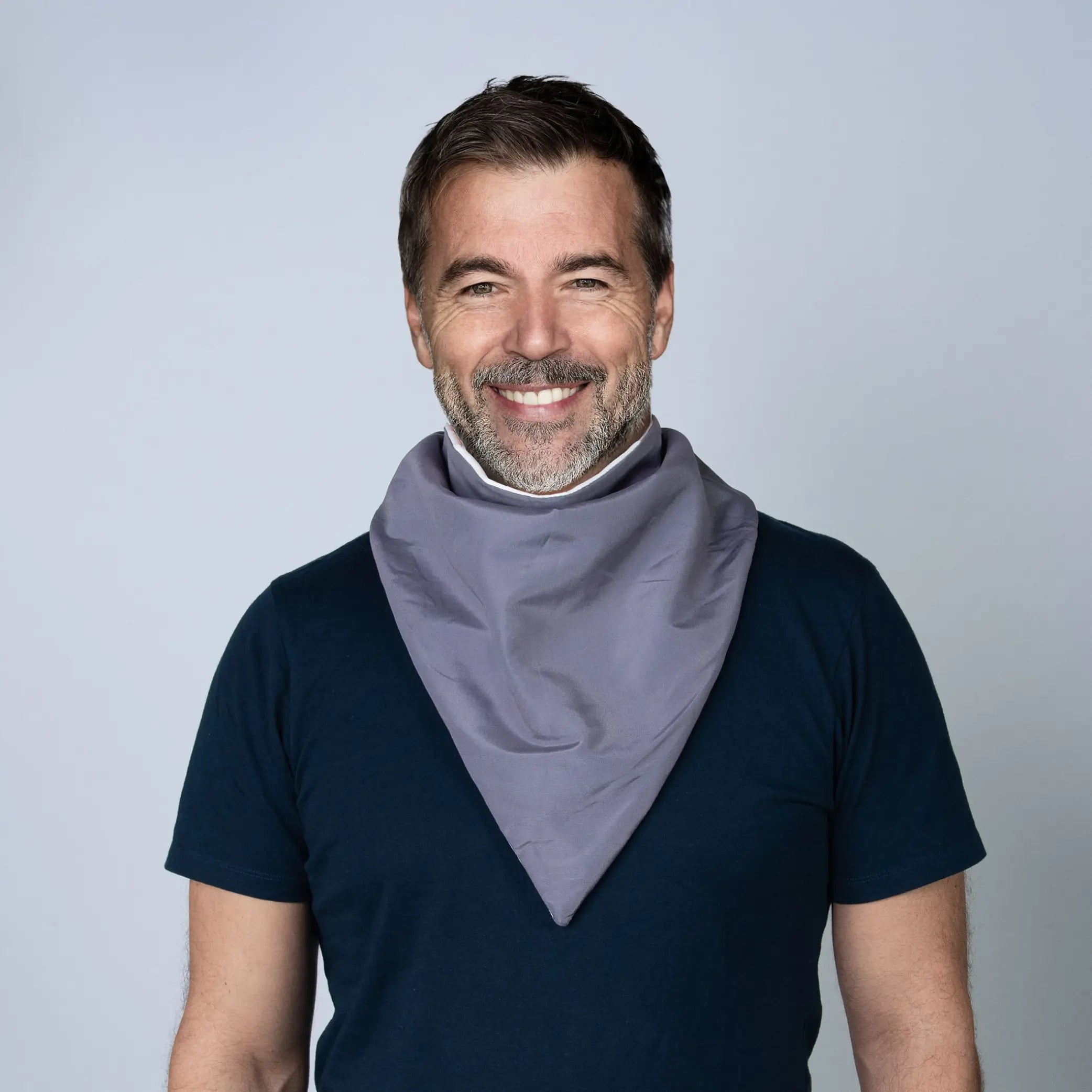 Man wearing a grey StayDry absorbent and waterproof bandana bib, offering stylish and discreet protection for adults with disabilities, senior