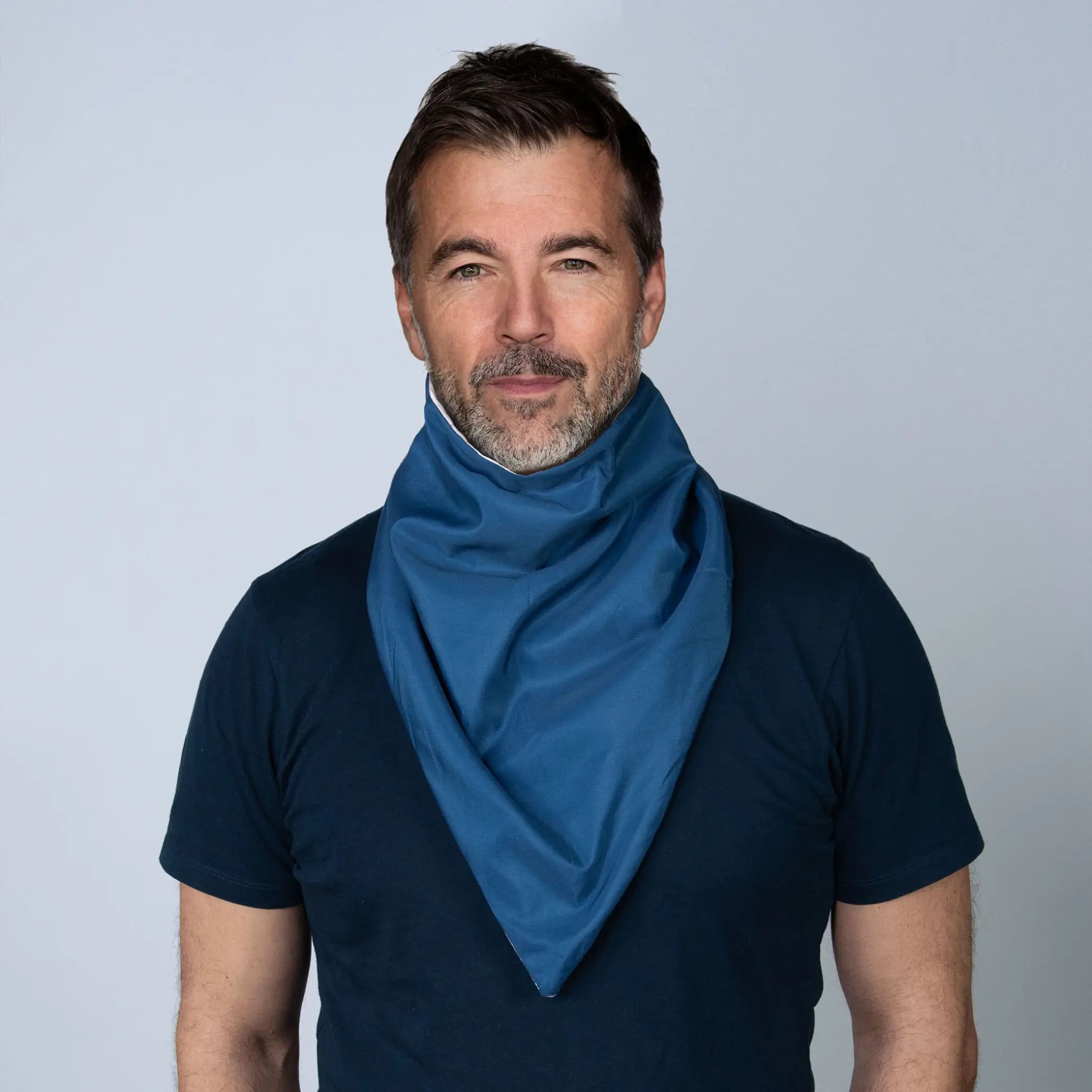 Man wearing a navy StayDry absorbent and waterproof bandana bib, designed for adults needing stylish and discreet protection 