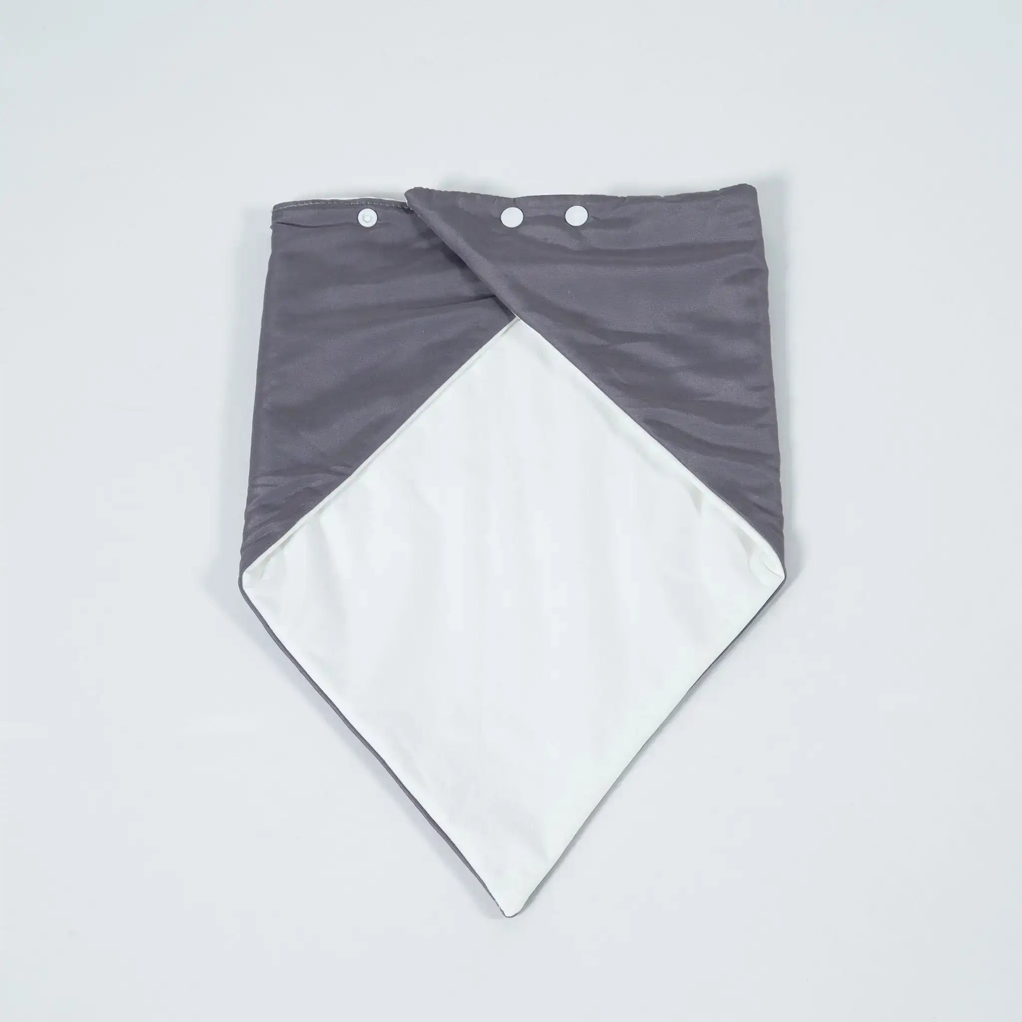 Flat lay of a grey StayDry absorbent and waterproof bandana bib with white lining, designed for adults and seniors needing stylish, discreet, and leak-proof protection.