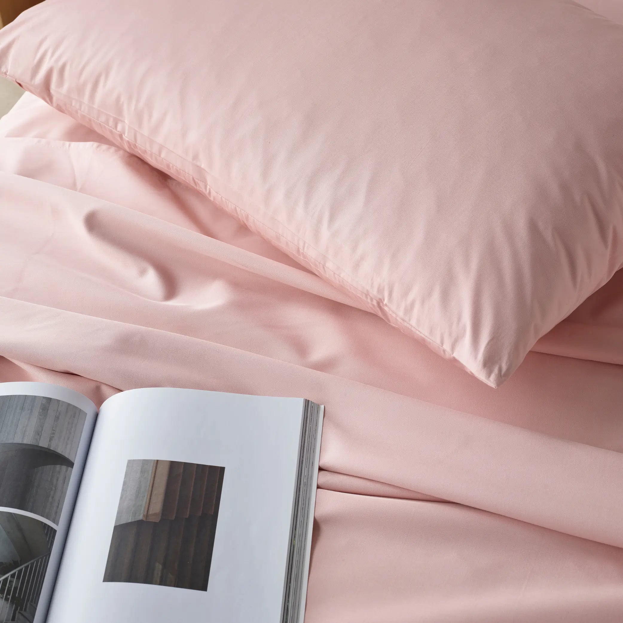 Close-up of blush waterproof bamboo sheet set, showcasing ultra-soft, silky fabric with a luxurious feel. These breathable, hypoallergenic sheets offer moisture-resistant and stain-proof protection for ultimate comfort.