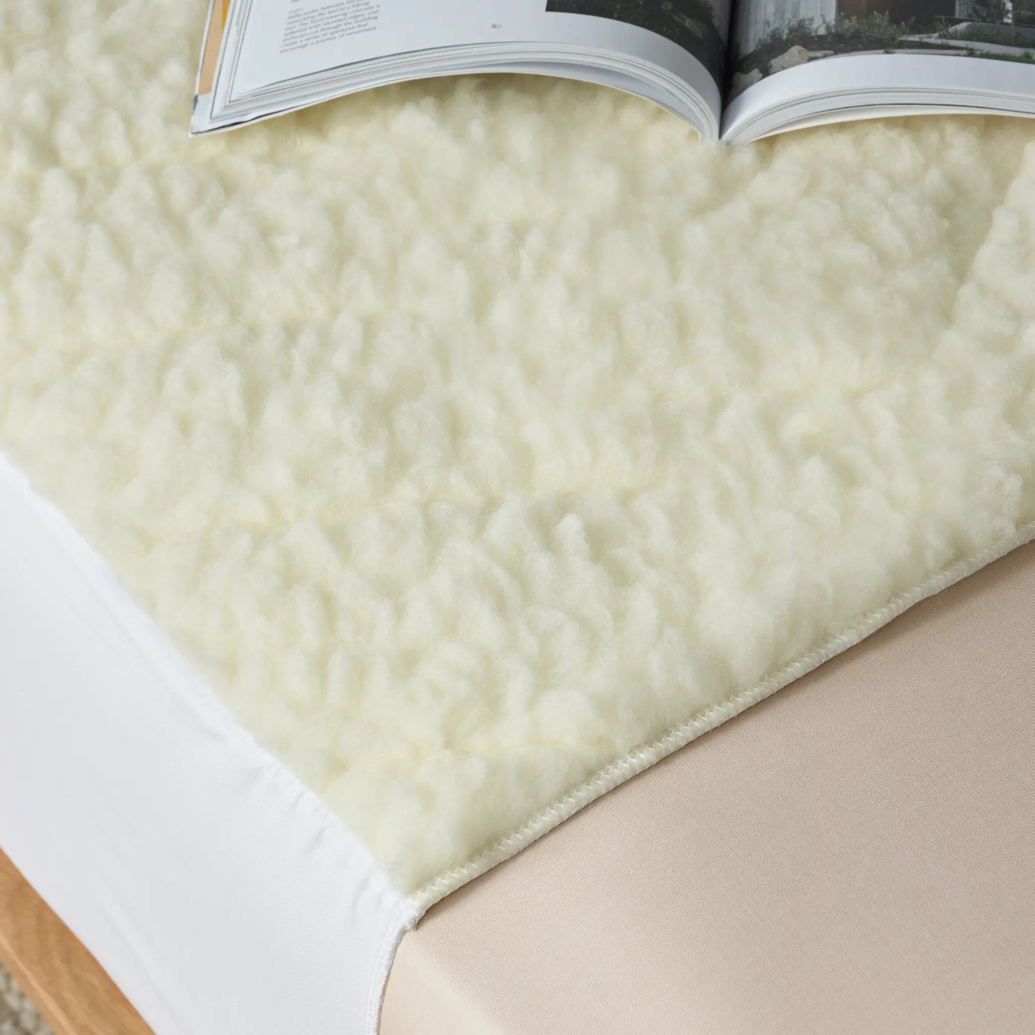 Close-up of a plush waterproof wool mattress topper with soft, breathable fleece texture, designed for ultimate comfort and mattress protection. Ideal for temperature regulation and moisture control, this hypoallergenic topper enhances sleep quality 