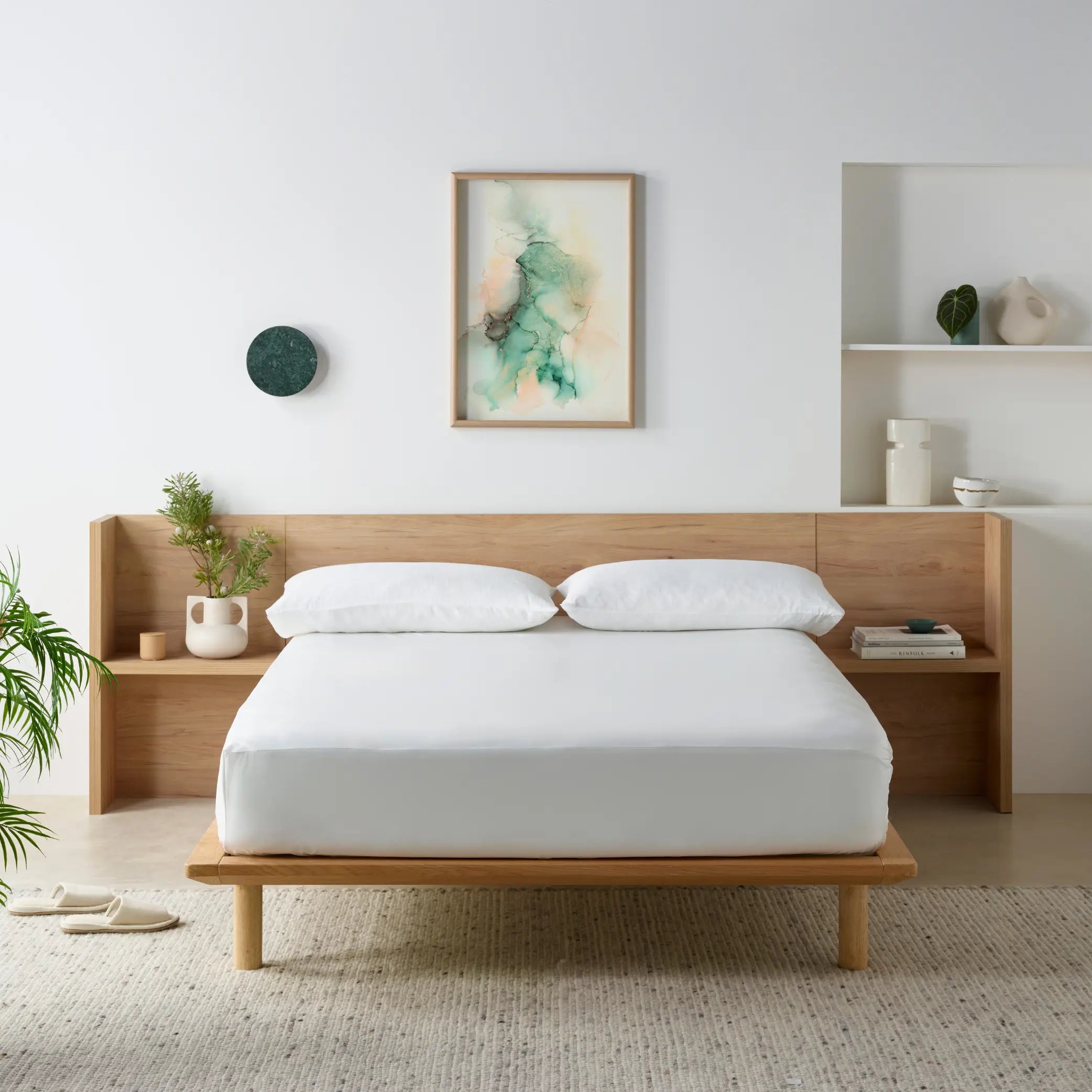 Minimalist bedroom featuring the Duratherme Waterproof Mattress Protector on a wooden bed frame. This premium waterproof and hypoallergenic mattress cover