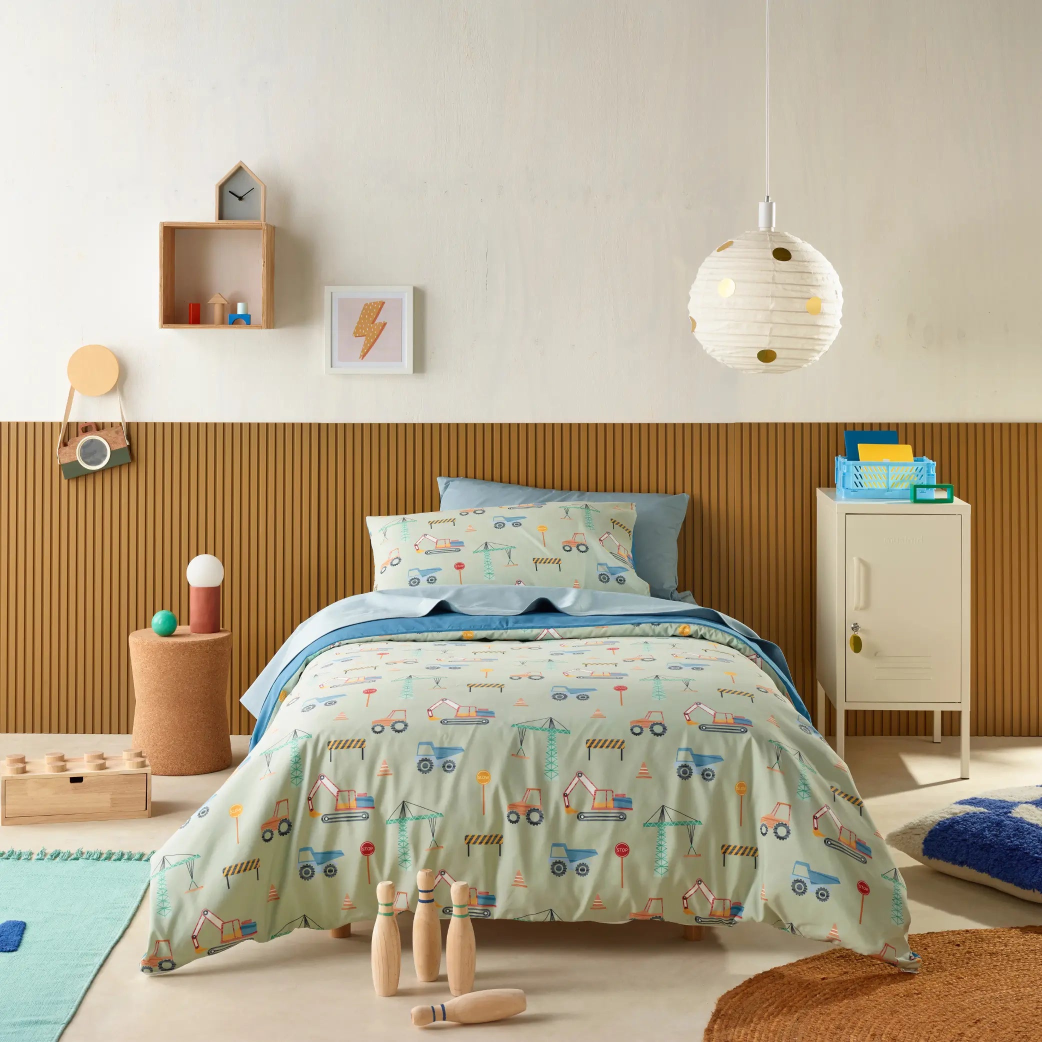 Kids' bedroom styled with a water-resistant quilt cover set featuring a fun construction and vehicle-themed design