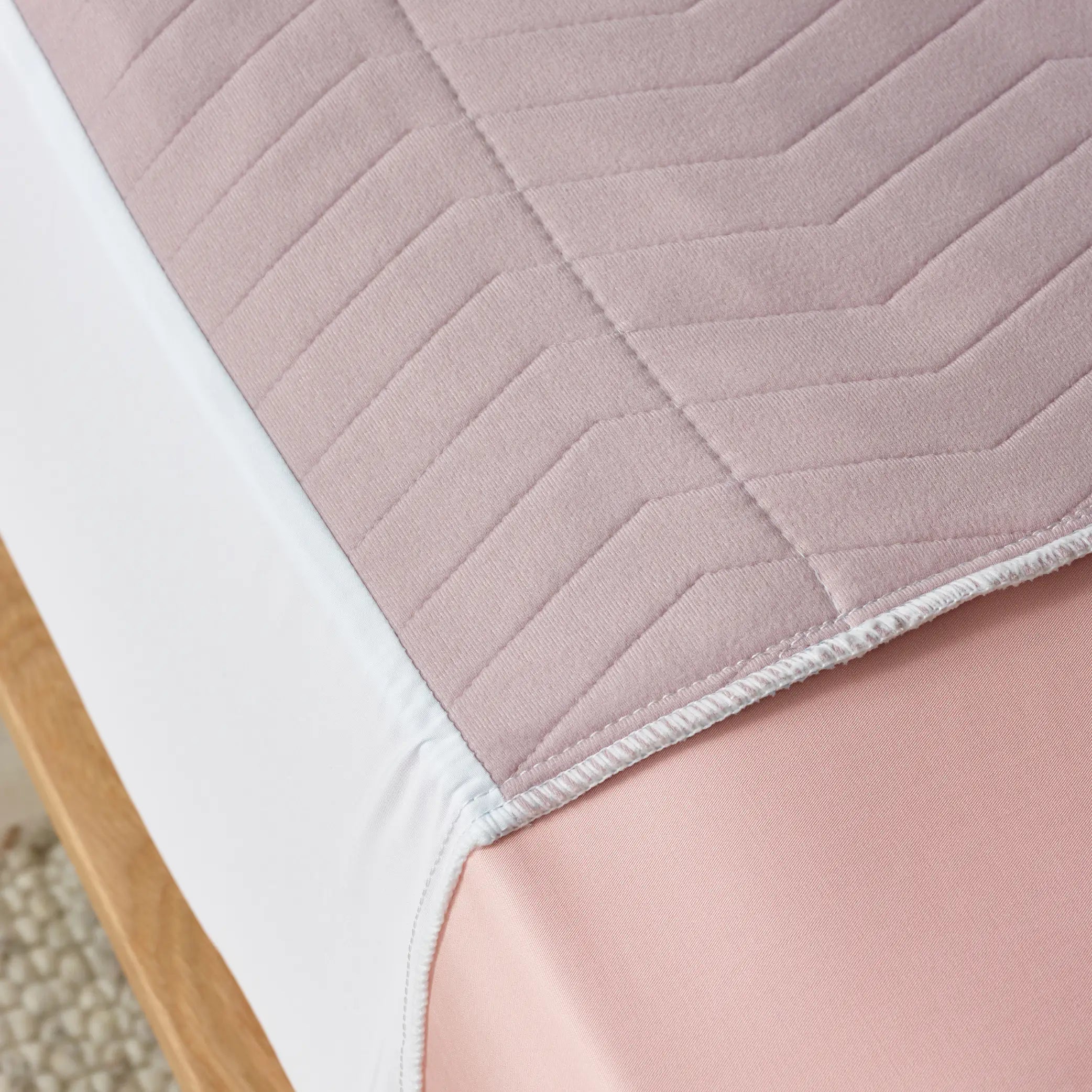 Close-up of the Lilac waterproof bed pad showcasing soft quilted texture and leak-proof protection.