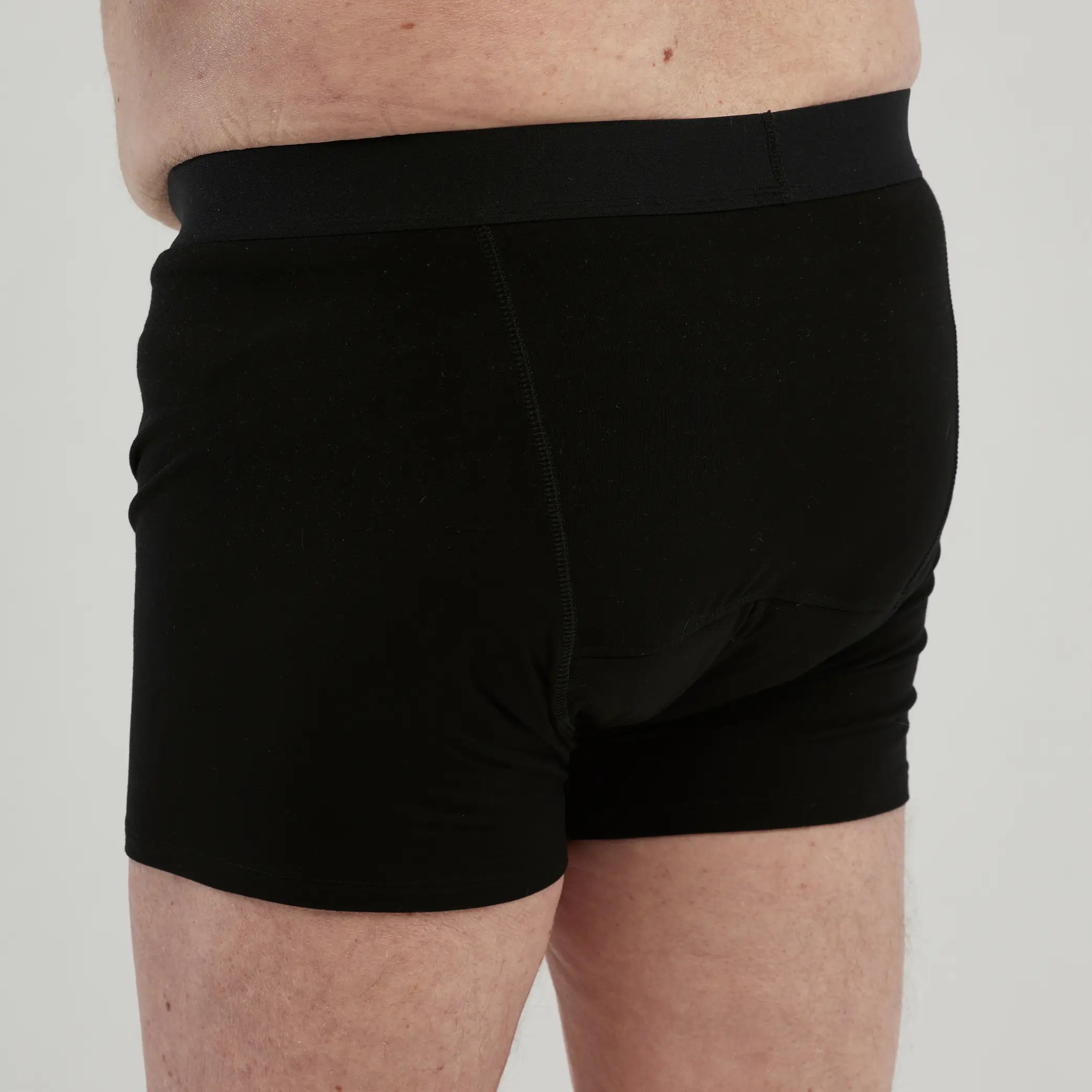 Side view of StayDry men's waterproof incontinence boxer briefs in black. Designed for maximum absorbency and discreet protection, these leak-proof underwear provide comfort and security for daily wear.