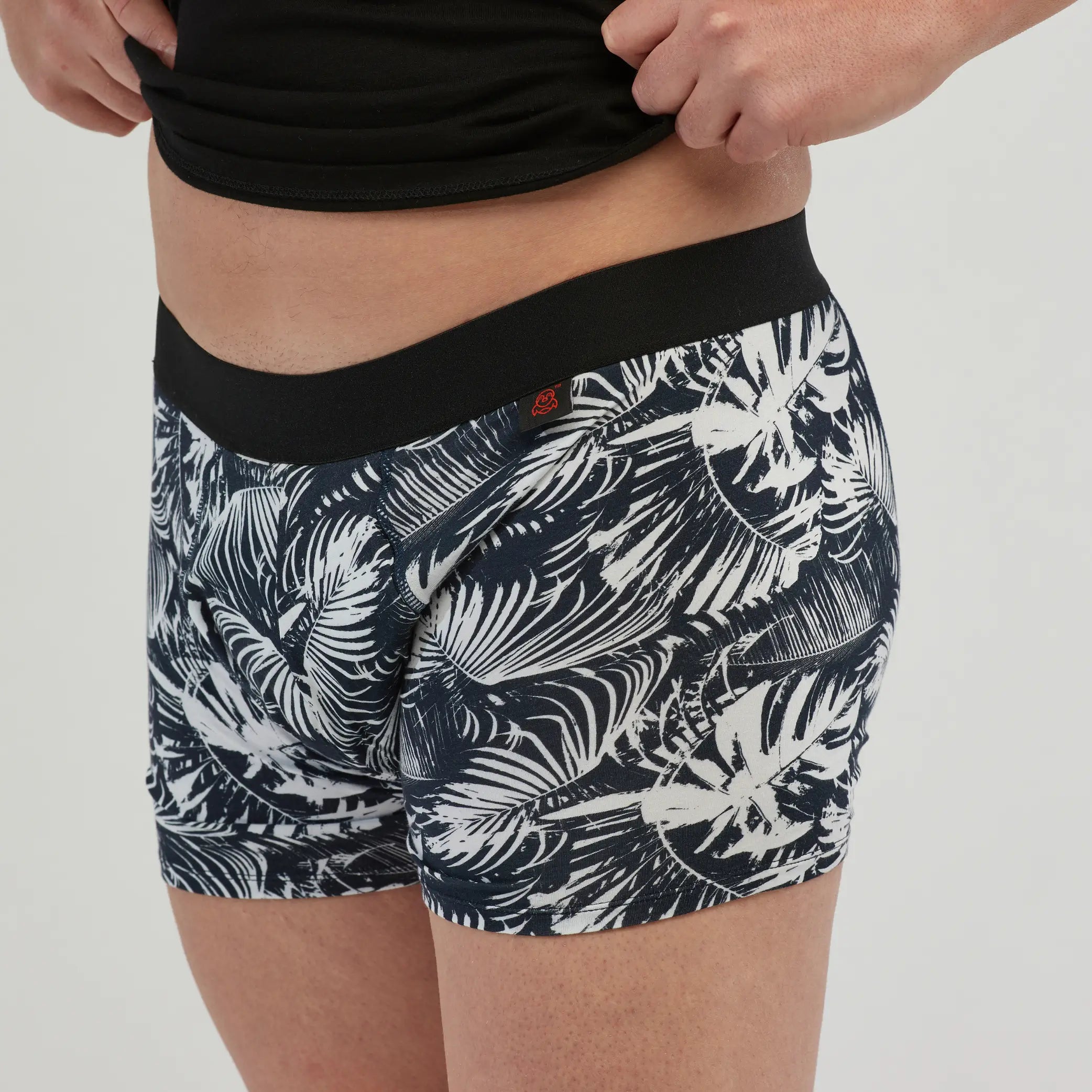 Side view of StayDry men's waterproof incontinence trunks with a black and white tropical print. 