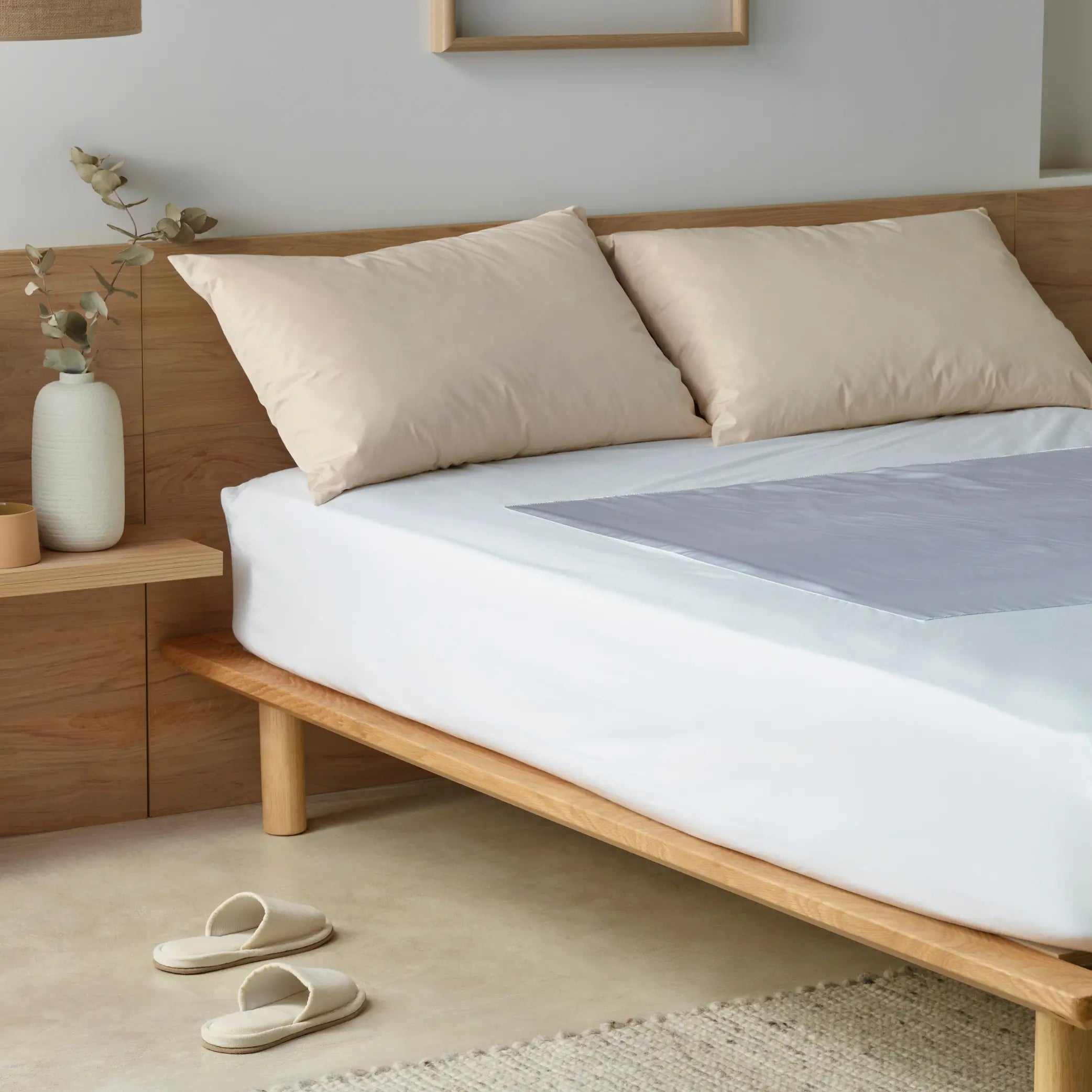 A modern bedroom featuring the Mobility Assist Waterproof Bed Protector with StayDry technology. This waterproof bed cover offers superior incontinence protection.