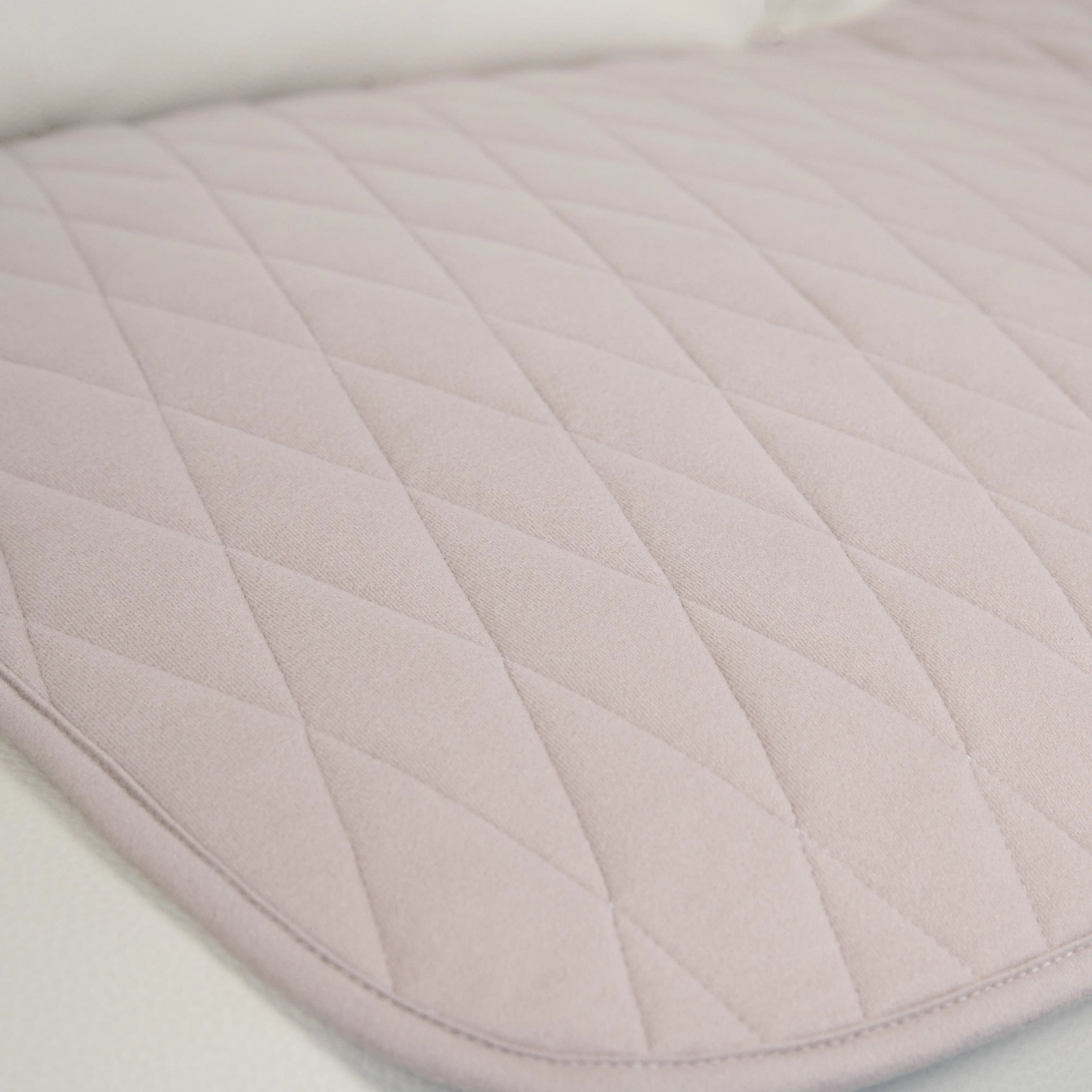 Close-up of the bone-coloured waterproof couch pad featuring a quilted, ultra-absorbent surface. Designed for incontinence protection, spills, and pet messes. Soft, durable, and stylish furniture protector.