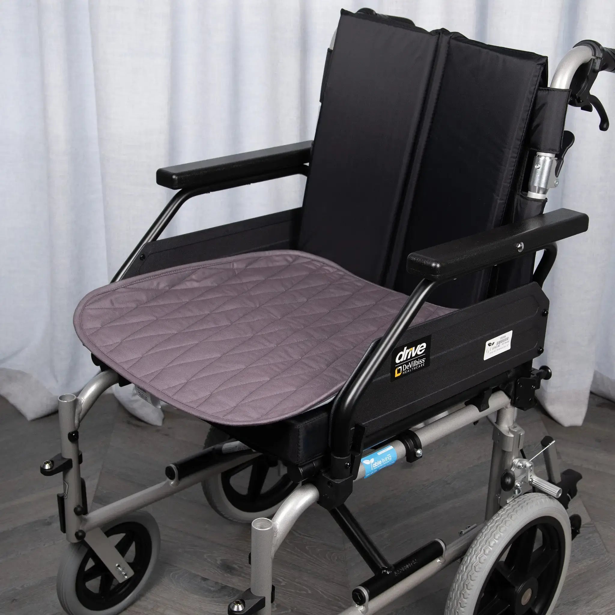 Greystone waterproof wheelchair pad with a quilted, absorbent design for incontinence protection. Ideal for mobility support, providing a comfortable and secure fit on standard wheelchairs, protecting against spills and leaks.