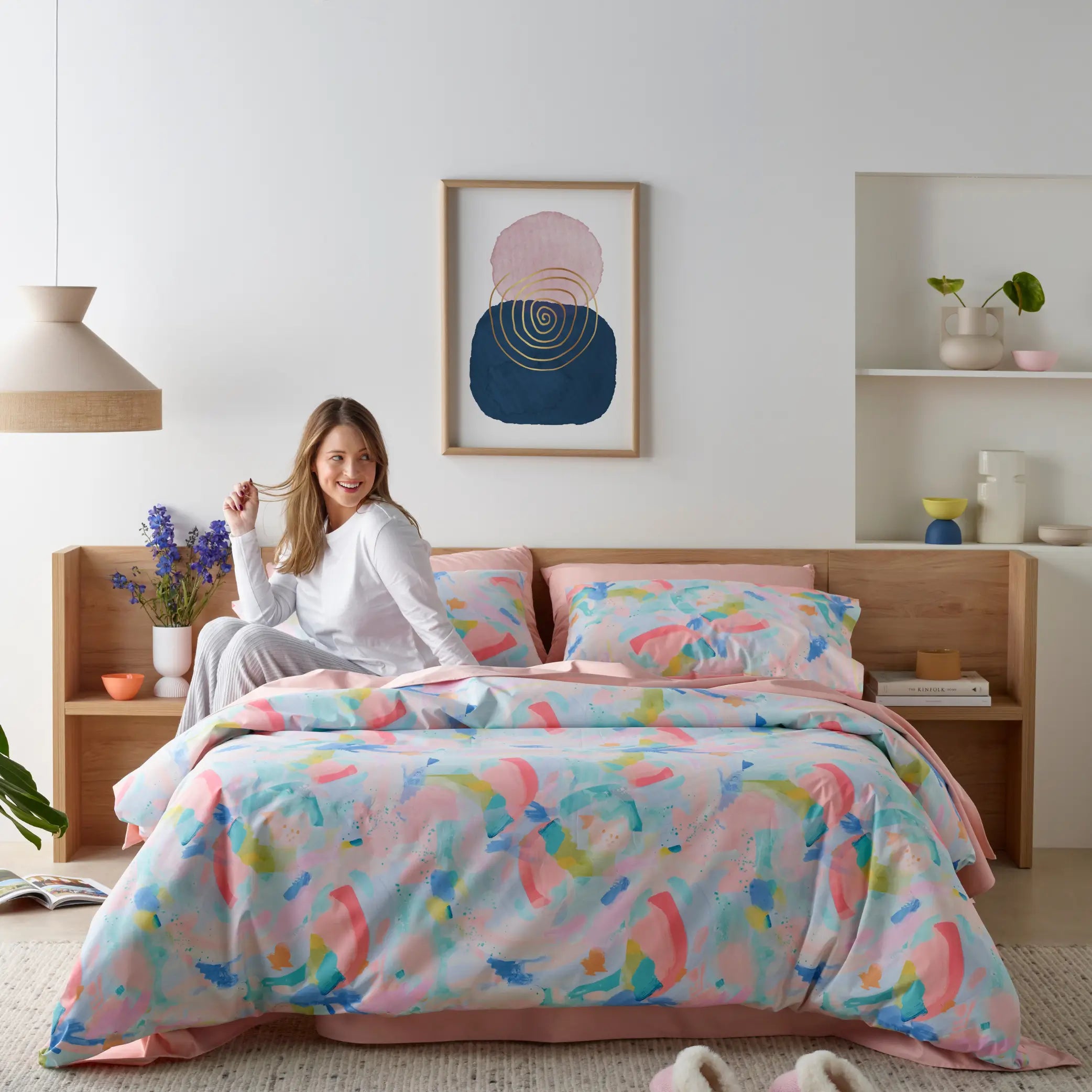 Bright and colourful Wonderlust by Deb McNaughton waterproof quilt cover set in a modern bedroom. This limited-edition bedding features an abstract, artistic print with soft pastel hues, adding a vibrant touch to any space. Designed with a waterproof layer for ultimate protection and durability.